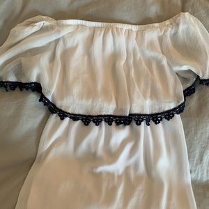 White strapless blouse with blue trim.